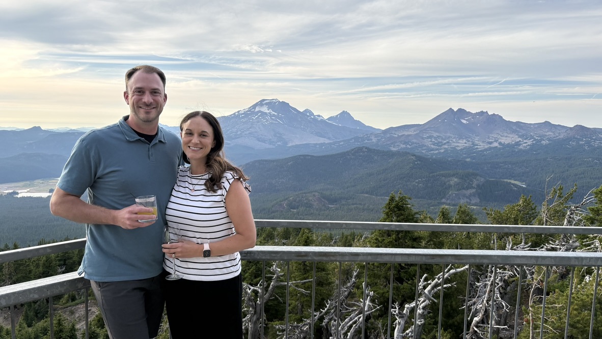Sam and his wife together at Mt. Bachelor, with the Cascade mountains behind them